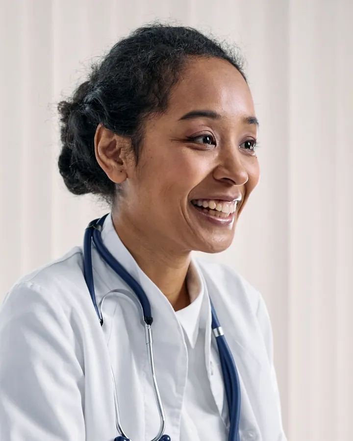 Dr. Imani Brooks laughing during a conversation at her desk